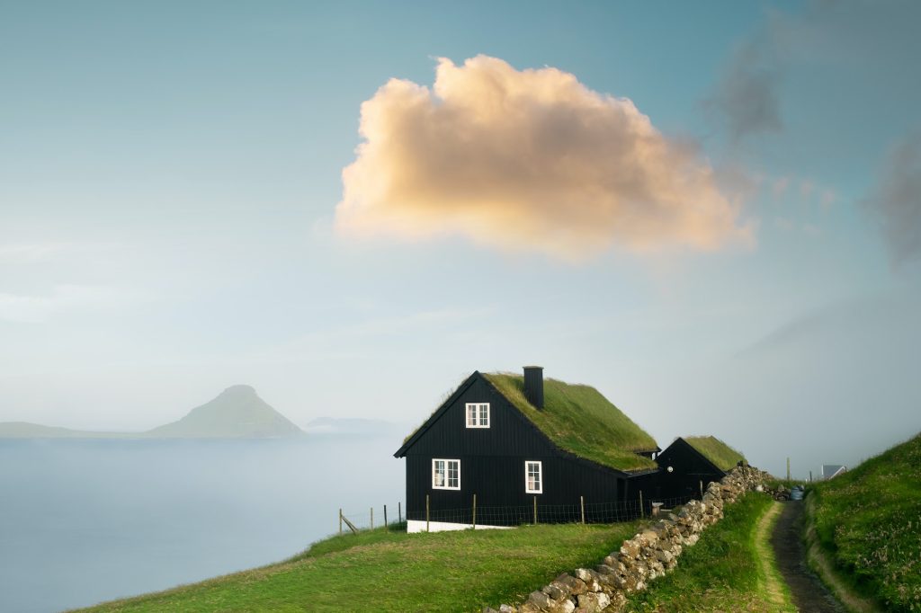 Foggy morning view of a house with typical grass roof